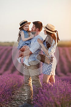 Happy family in laveder field. mother, father and child in sunset light in blooming lavender