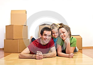 Happy family laying on the floor in their new home