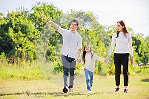 Happy family life concept. Asian parents Father, Mother and the little girl walking and have fun and enjoyed ourselves together