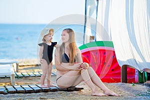 Happy family lifestyle. Relaxing and enjoying life. Bright colors. Top view Young mother with cute daughter Summer travel, water