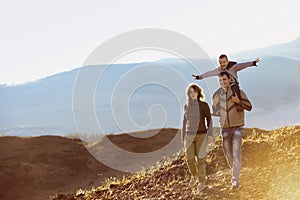 Happy family walking nature mountains area