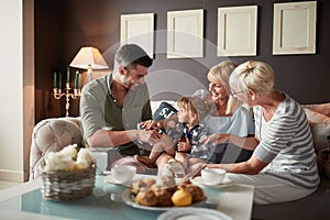 Happy family with little girl visiting grandma