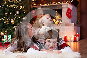 Happy family with little son lying near Christmas