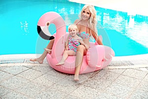 Happy family look summer vacations. Beautiful mother having fun with daughter.  Blonde pretty woman with her little girl wears in
