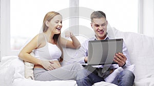 Happy family looking with laptop computer