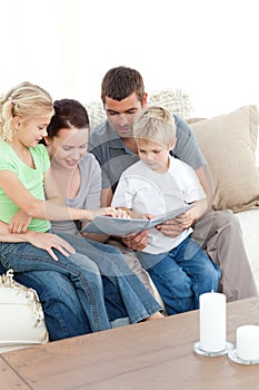 Happy family looking at a photo album