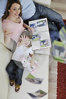 Happy family looking photos at home