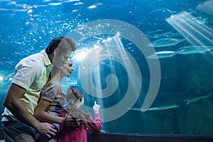 Happy family looking at tank