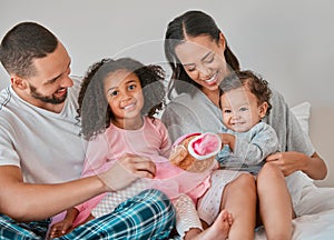 Happy family, love and bedroom with child, baby and parents together on a bed for care, bonding and quality time at home