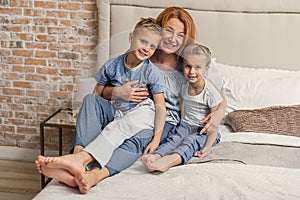 Happy family lying down on bed at home