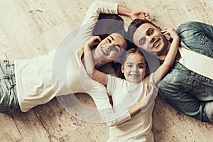 Happy Family Lying of Floor Together at Home