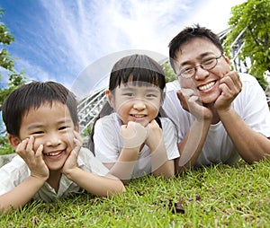 Happy family lying on the grass