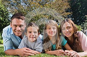 Happy family lying on the grass