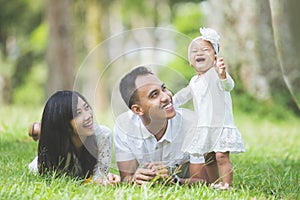 Happy family lying in the grass