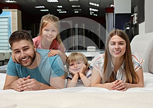 Happy family lying on new orthopedic mattress