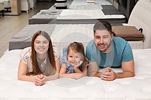 Happy family lying on new orthopedic mattress