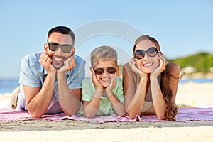 Happy family lying on summer beach