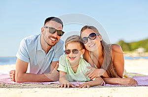 Happy family lying on summer beach