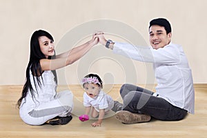 Happy family making the home sign at home