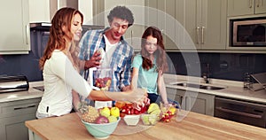 Happy family making smoothie