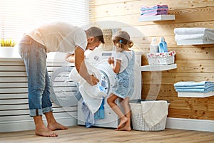 Happy family man father householder and child in laundry with