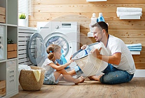 Happy family man father householder and child in laundry with