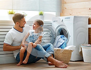 Happy family man father householder and child in laundry with