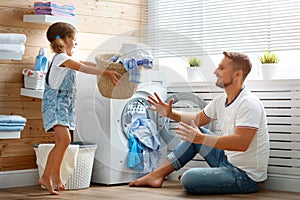 Happy family man father householder and child in laundry with