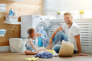 Happy family man father householder and child in laundry with