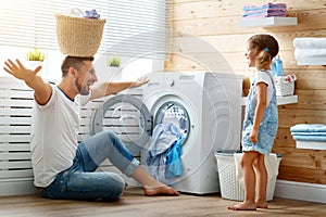 Happy family man father householder and child in laundry with