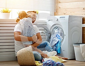 Happy family man father householder and child in laundry with