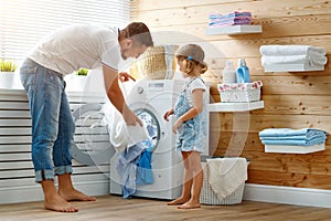 Happy family man father householder and child in laundry with