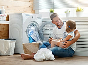 Happy family man father householder and child in laundry with