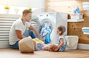 Happy family man father householder and child in laundry with photo