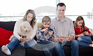 Happy family members spending time playing with smartphones