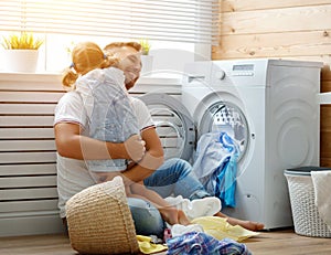 Happy family man father householder and child in laundry with photo