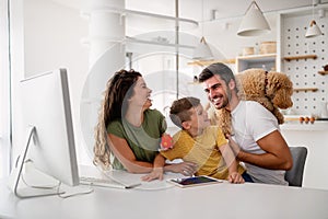 Happy family with modern devices and dog having fun, playing at home