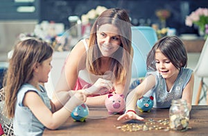 Happy Family mom daughter save money piggy bank future investment savings photo