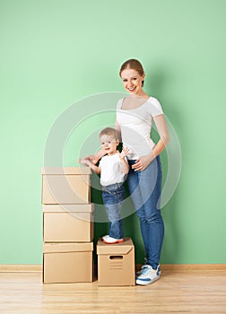 Happy family mother and baby daughter in an empty apartment with