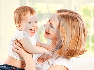 Happy family. Mother and baby daughter laugh and embracing