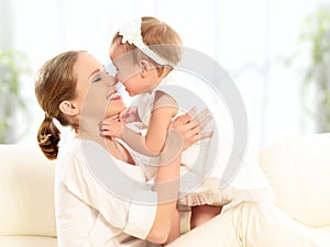 Happy family. Mother and baby daughter plays, hugging, kissing