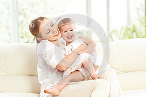 Happy family. Mother and baby daughter plays, hugging, kissing