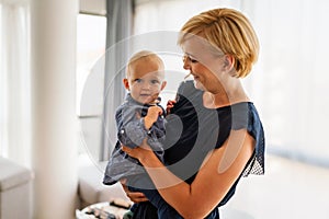 Happy family. Mother and baby daughter plays, hugging, kissing at home