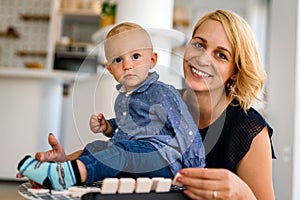 Happy family. Mother and baby daughter plays, hugging, kissing at home