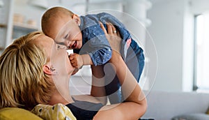 Happy family. Mother and baby daughter plays, hugging, kissing at home