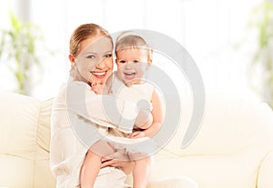 Happy family. Mother and baby daughter plays, hugging, kissing