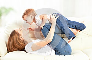 Happy family. Mother and baby daughter plays, hugging, kissing