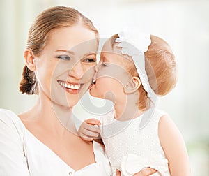 Happy family. Mother and baby daughter plays, hugging, kissing