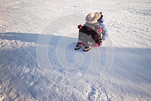 happy family mother and baby girl daughter playing and laughing in winter outdoors in the snow