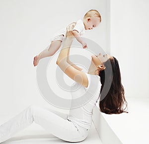 Happy family, mother and baby having fun together at home